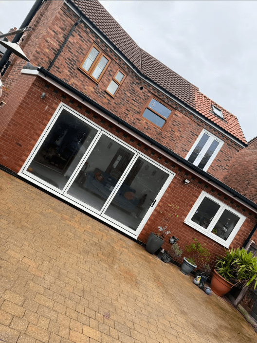 Completed rear extension in Moreton, Wirral — bifold doors and new patio