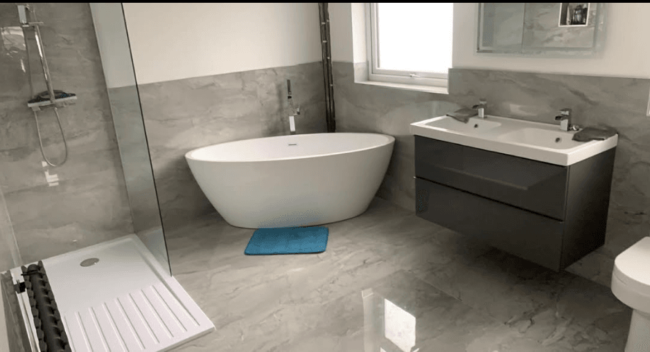 Bathroom fit-out Upton Wirral — freestanding bath and marble-effect tiling